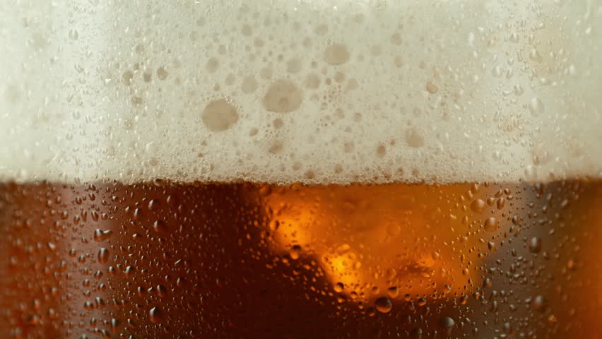 Super slow motion of pouring beer into pint . Filmed on high speed cinema camera, 1000 fps .