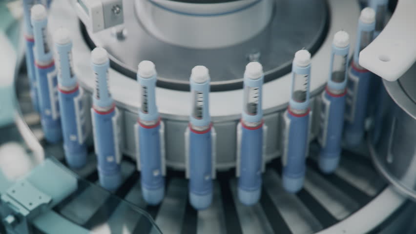 Insulin Injection Pens on Rotary Conveyor Line during Production Process at Modern Pharmaceutical Factory. Weight Loss Medication Manufacturing. Medicinal Drug Production Plant.