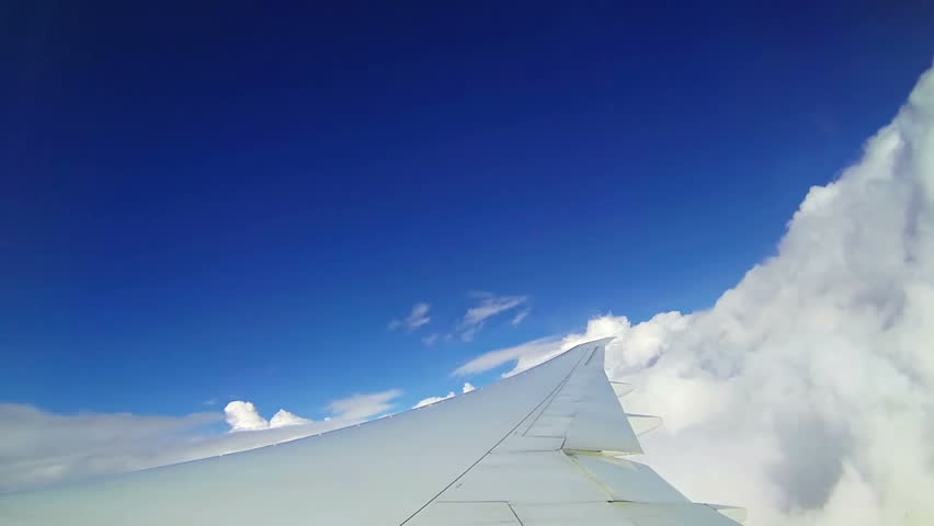 Moving clouds, airplane in the sky