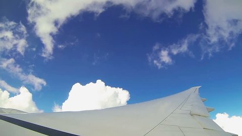 Moving clouds, airplane in the sky