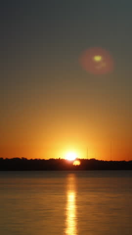 Colorful Sunset over Water Vertical Video Timelapse Background
