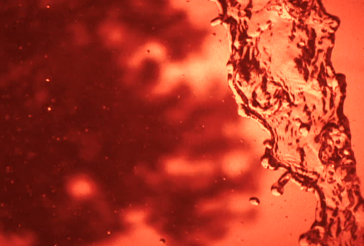 Background texture of water pouring with red filter.