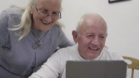 Elderly couple enjoying a joyful online chat on a tablet, showcasing technology's role in connecting loved ones. - Powered by Shutterstock - Get 15% off with code: PIKWIZARD15