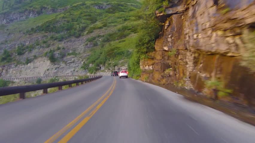 Following vehicles on Going To The Sun Road during summer at Glacier National Park, Montana, USA
