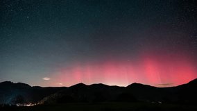 Starry night sky with stars and red aurora borealis motion in middle Europe countryside Time lapse - Powered by Shutterstock - Get 15% off with code: PIKWIZARD15
