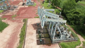 Wells with pump jacks on oil field,  Rigs for crude fossil extraction working on oilfield - Powered by Shutterstock - Get 15% off with code: PIKWIZARD15