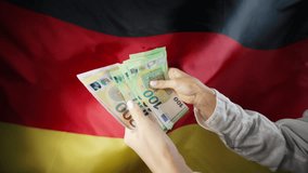 German flag background. Woman counting money euros. Credits, raising tariffs in Germany, EU Europe, traveling costs, financial concept. - Powered by Shutterstock - Get 15% off with code: PIKWIZARD15