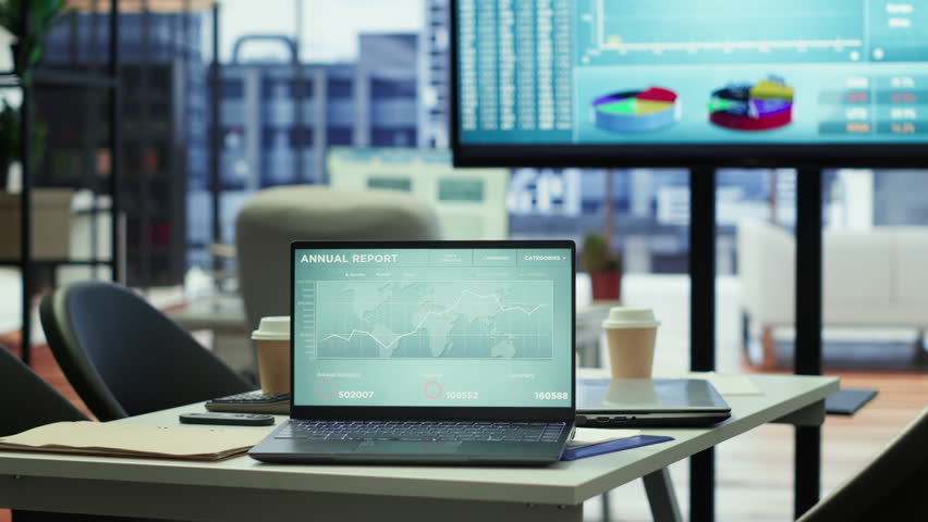 Sleek corporate office with a computer displaying detailed infographics, perfect for executive business meetings or financial planning and project development in a multinational company.