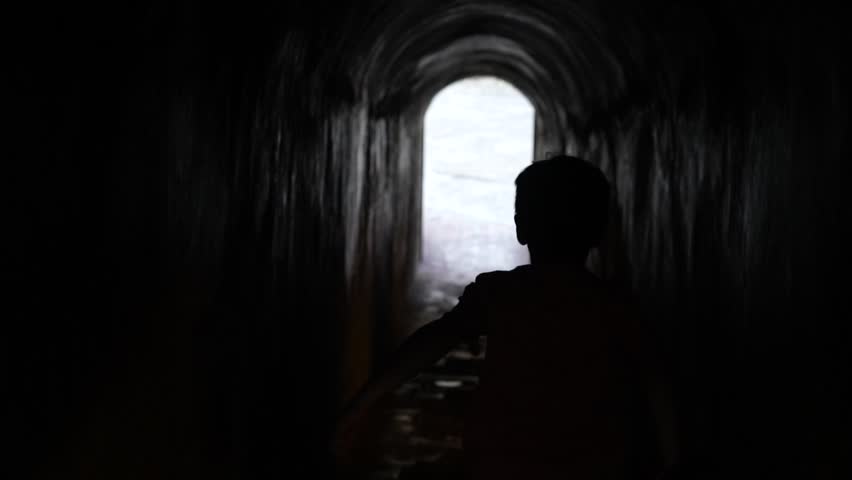 A child running through a tunnel