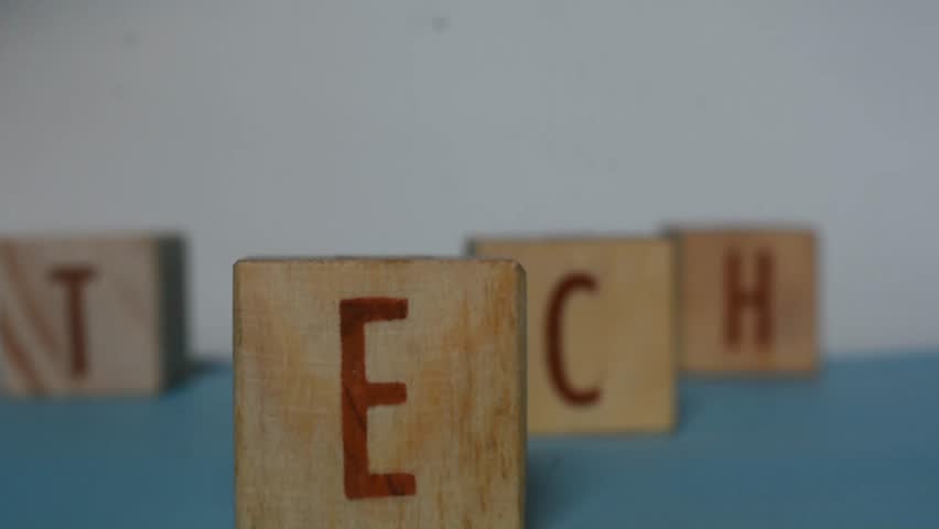 "TECH" word written on wood block. Content text on wooden table for your desing, concept.