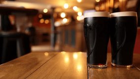Two pints of stout on a pub table - Powered by Shutterstock - Get 15% off with code: PIKWIZARD15