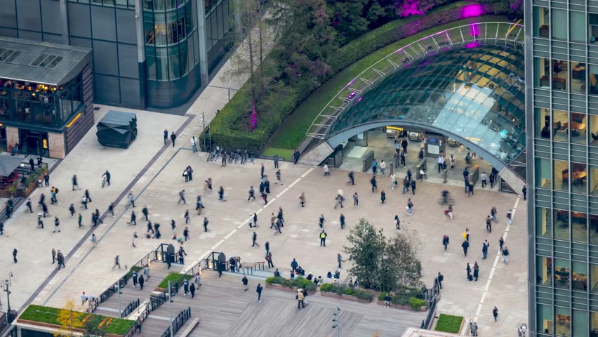 Time lapse view of the busy Canary Wharf tube station with commuter people rushing over the square from work in London, England
