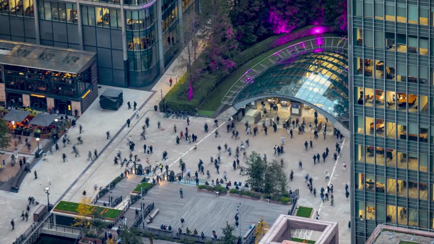Time lapse view of the busy Canary Wharf tube station with commuter people rushing over the square from work in London, England