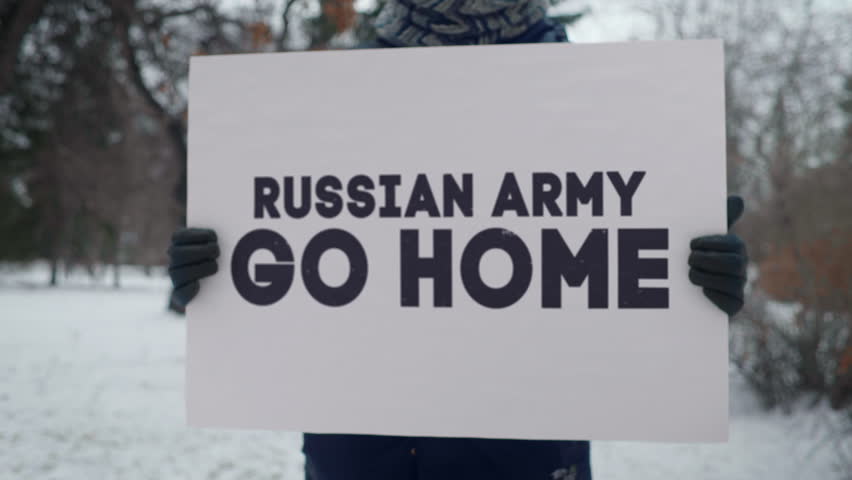 Demonstration against the ongoing war in Ukraine. Demonstrating support for suffering Ukrainian people during the war. Demonstrator with a sign Russian Army Go Home protesting the war in the Ukraine.