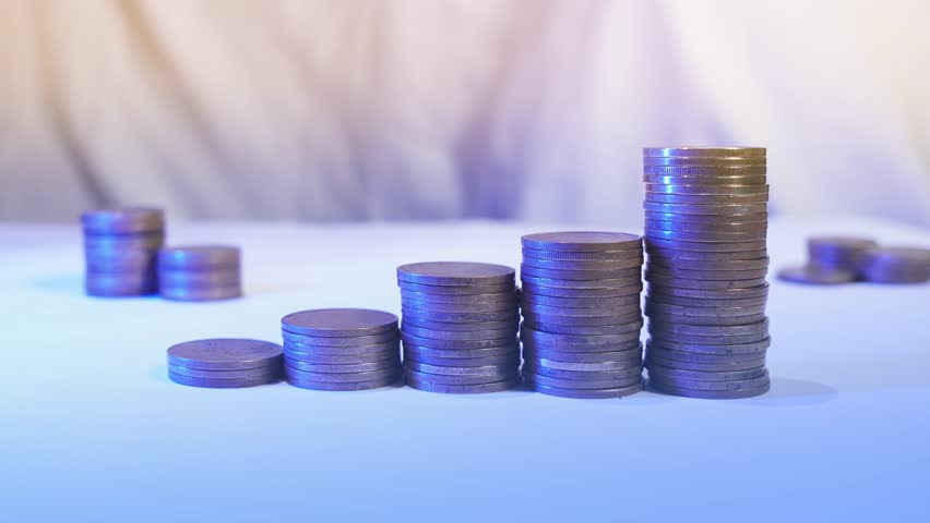 Hand puts coin to stack. Money interest rate increase concept, percentage commission credit. Double exposure of graph and rows of coins