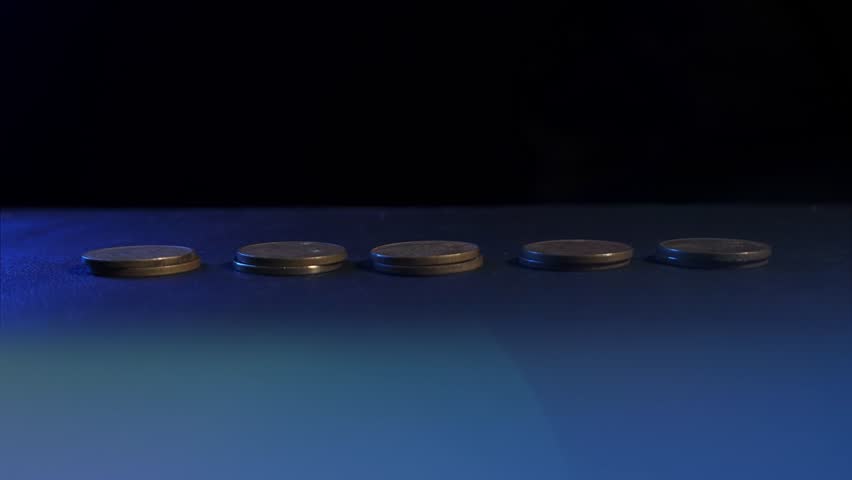 Graph and rows of coins for finance concept. Time lapse of gold coins piling up