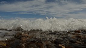 Sea wave breaks on pebble shore and forms many air bubbles underwater, dissolving in water and enriching coastal sea zone with oxygen, Close-up, Underwater view, Slow motion - Powered by Shutterstock - Get 15% off with code: PIKWIZARD15