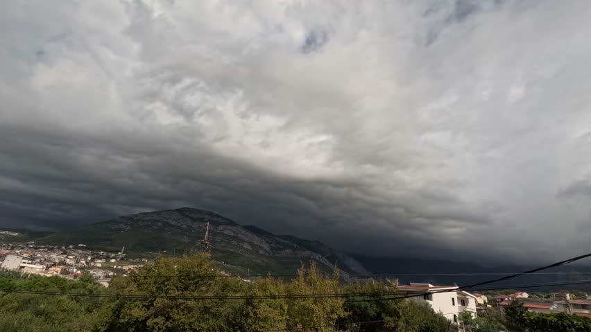 timelapse of heavy clouds flying over mountain
