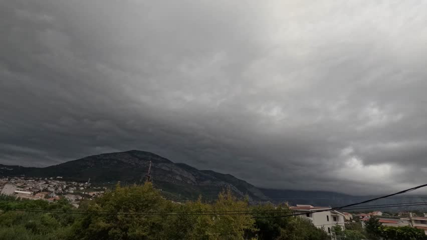 timelapse of heavy clouds flying over mountain