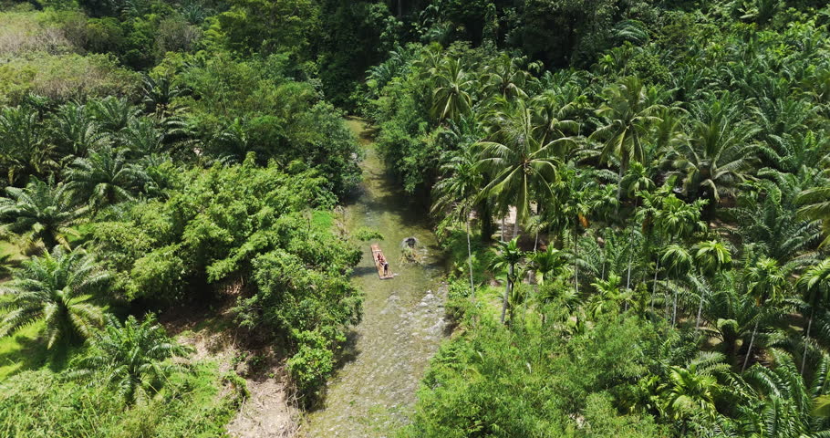 bamboo rafting boat flowing through canal river wilderness forest. Travel natural adventures holiday summer aerial view. outdoor activities