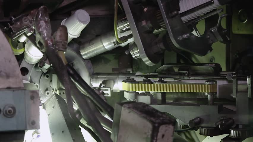 Labeling plastic food containers. High speed labeling machine in industrial factory. Machine for sticker on product in manufacture. Flexible packaging. Labeling machine in industrial factory.