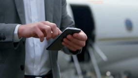 Animation of spinning globe over caucasian businessman using smartphone at airport. Global business and digital interface concept digitally generated video. - Powered by Shutterstock - Get 15% off with code: PIKWIZARD15