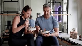 Eating Healthy Food Salad In Gym. Fit Athlete Couple - Powered by Shutterstock - Get 15% off with code: PIKWIZARD15