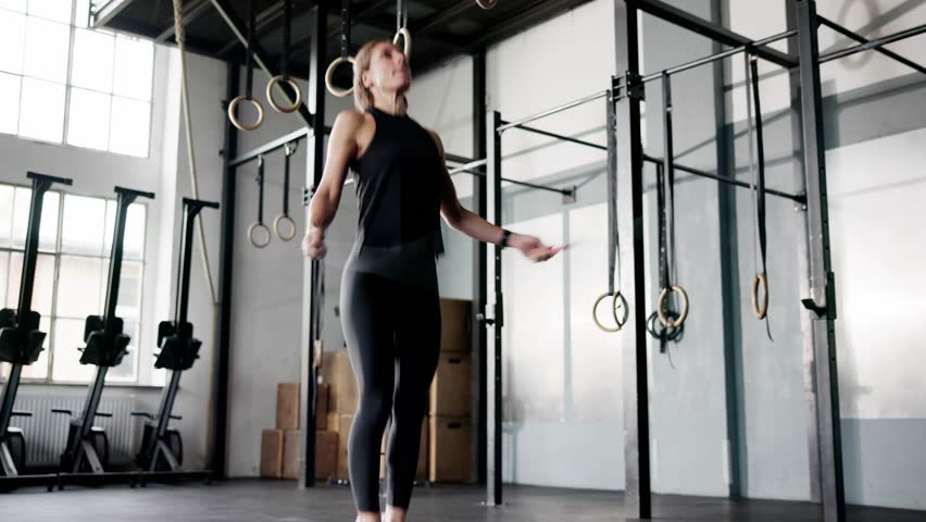 Woman Training With Jump Rope In Fitness Gym