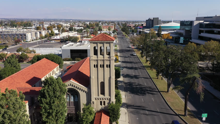 Bakersfield, California, USA - November 24, 2023: Afternoon sun shines on a historic church and urban core of downtown Bakersfield.