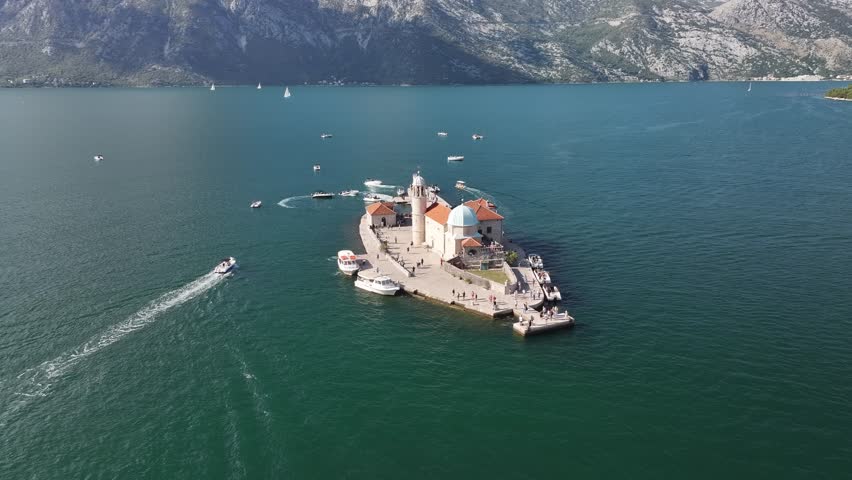 Aerial view of Lady of The Rock and Saint George islands in Kotor Bay surrounded by stunning blue waters and mountain scenery, Montenegro, Europe