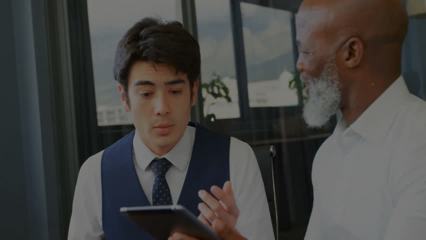 Animation of network processing over diverse male colleagues with tablet talking at office. Business, connection, teamwork, digital interface and communication, digitally generated video. - Powered by Shutterstock - Get 15% off with code: PIKWIZARD15