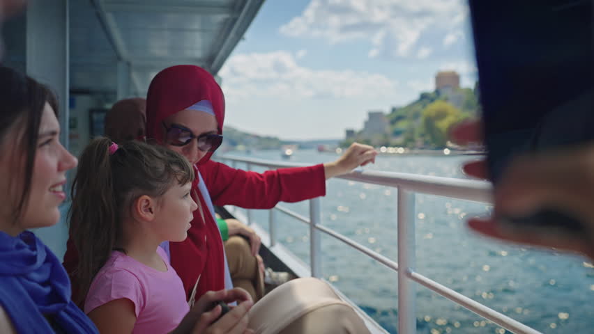 Muslim Mother and Daughter Sightseeing Istanbul from a Ferry Boat on Sunny Summer Day. Concept of Turkey, Travel, Exploring, Vacation, Tourism, Cruise, Discovery, Journey, Holiday, Family Trip