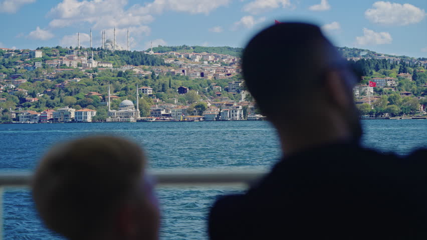 Father and Son Talking During Bosphorus Sightseeing Tour of Istanbul from a Ferry Boat on Sunny Summer Day. Concept of Travel, Exploring, Vacation, Tourism, Cruise, Discovery, Journey