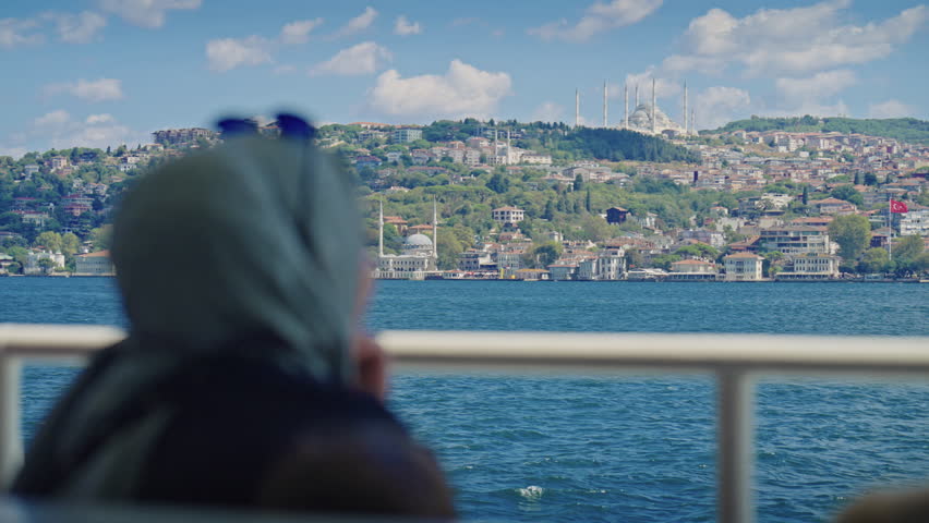 Muslim Woman in Hijab Enjoying View During Bosphorus Sightseeing Tour of Istanbul from a Ferry Boat on Sunny Summer Day. Concept of Travel, Exploring, Vacation, Tourism, Cruise, Discovery, Journey