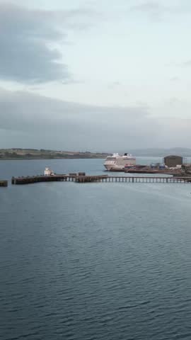 cruise ship docked scenic harbor port scotland, grand vessel against backdrop scottish landscape serene harbor aerial maritime tourism travel waterfront vacation seascape infrastructure