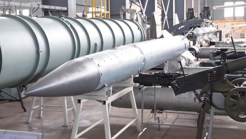 A huge combat missile and ammunition in a public hangar