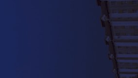 An intense thunderstorm lights up the sky as brilliant lightning strikes dramatically over a towering multi-story building, showcasing natures raw power against the urban landscape. Vertical video - Powered by Shutterstock - Get 15% off with code: PIKWIZARD15