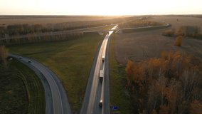 Trucks driving on the road in beautiful countryside in the autumn sunset, aerial view - Powered by Shutterstock - Get 15% off with code: PIKWIZARD15