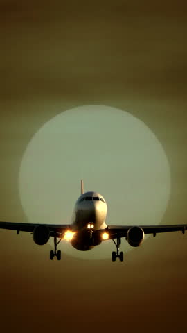 A silhouette of an airplane flies against a beautiful sunset, creating visual harmony