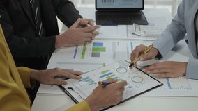 Business people analyzing a financial chart with a pen in an office setting, focusing on strategy and collaboration - Powered by Shutterstock - Get 15% off with code: PIKWIZARD15