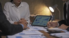 Business team reviewing financial data and key performance indicators on a digital tablet during a meeting - Powered by Shutterstock - Get 15% off with code: PIKWIZARD15