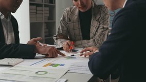 Businesspeople collaborating at a large table, analyzing financial data and discussing strategies for growth and success - Powered by Shutterstock - Get 15% off with code: PIKWIZARD15