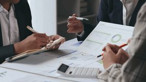 Business team analyzing financial reports and developing investment plans in a collaborative office setting - Powered by Shutterstock - Get 15% off with code: PIKWIZARD15