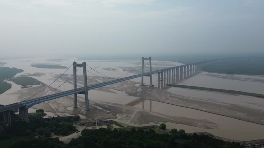 Aerial photo of the scenery around Taohuayu Yellow River Bridge in Zhengzhou City, Henan Province, China. This is the dividing line between the middle and lower reaches of the Yellow River.