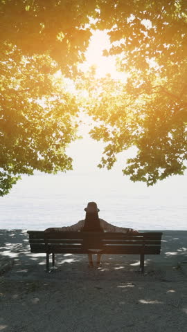 Experience a serene sunset by the lake while relaxing on a quiet bench, embracing tranquility