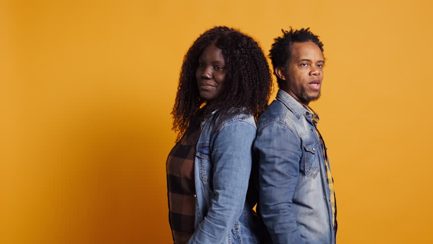 Furious offended couple having an argument and screaming at each other, dealing with marriage difficulties and misunderstandings. Annoyed frustrated man and woman quarreling. Camera B.