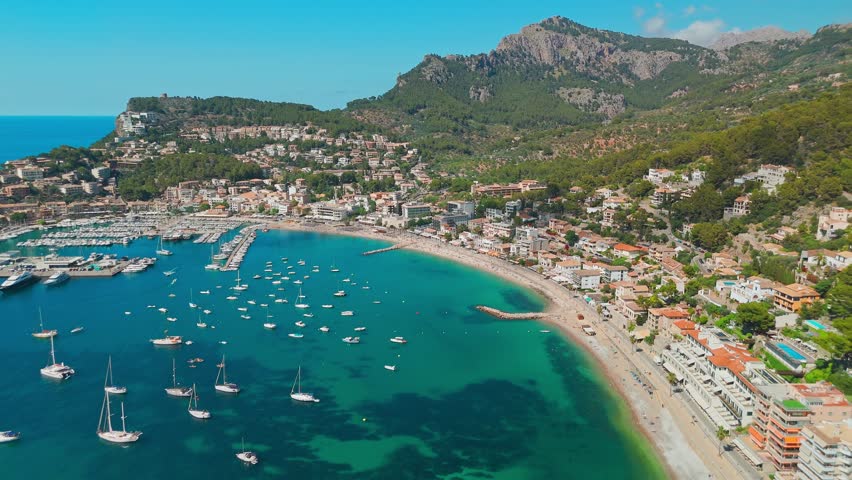 Aerial view of the summer resort town Port de Soller on Mallorca, Balearic Islands, Spain. The idyllic turquoise lagoon with moored yachts in it. Majorca, Spain.
