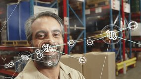 Animation of network of connections with icons over biracial male worker smiling in warehouse. Global business, teamwork and digital interface concept digitally generated video. - Powered by Shutterstock - Get 15% off with code: PIKWIZARD15