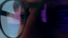 Eyes of Man in Glasses Looking at Computer Screen with Glowing Code of Web Development. Concentrated Sight of Programming Person Working Online on Internet Site. Macro Shot View of Moving Purple Image - Powered by Shutterstock - Get 15% off with code: PIKWIZARD15