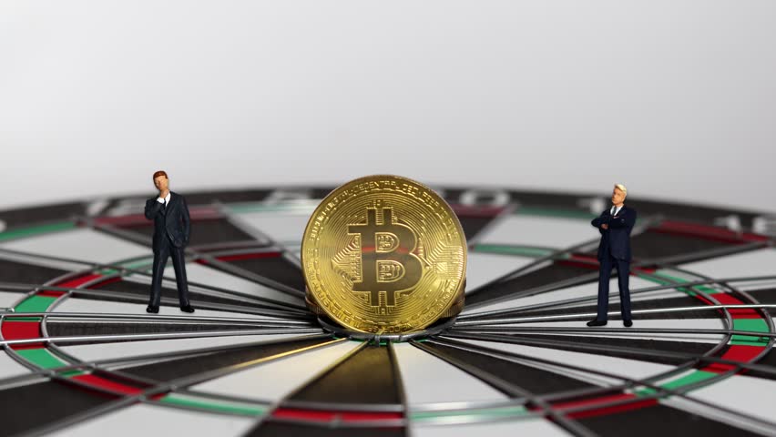 Bitcoin and two miniature businessmen on target.